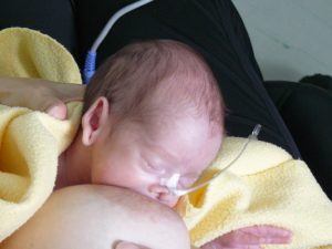 A baby born at 28 weeks, breastfeeding and latched on at 2 weeks of age.