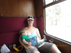 A toddler breastfeeding in a train. A perfectly normal thing to do.